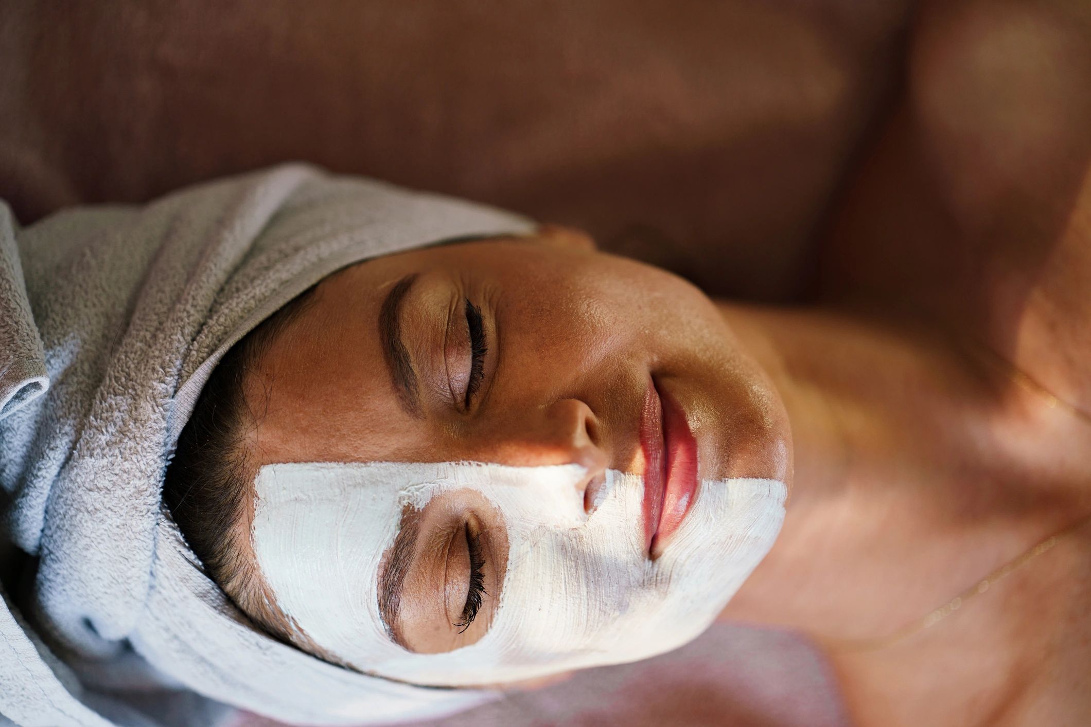 Woman enjoying relaxing facial mask spa treatment