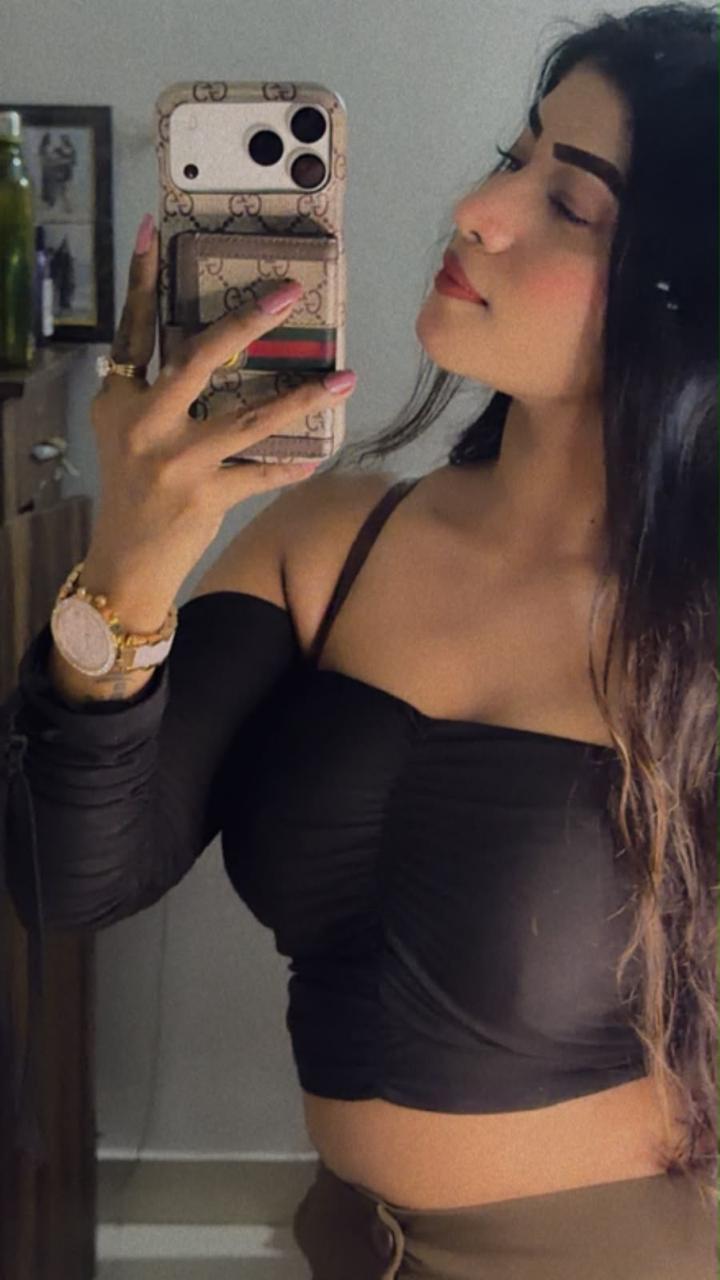 Portrait mirror selfie in a black outfit indoors