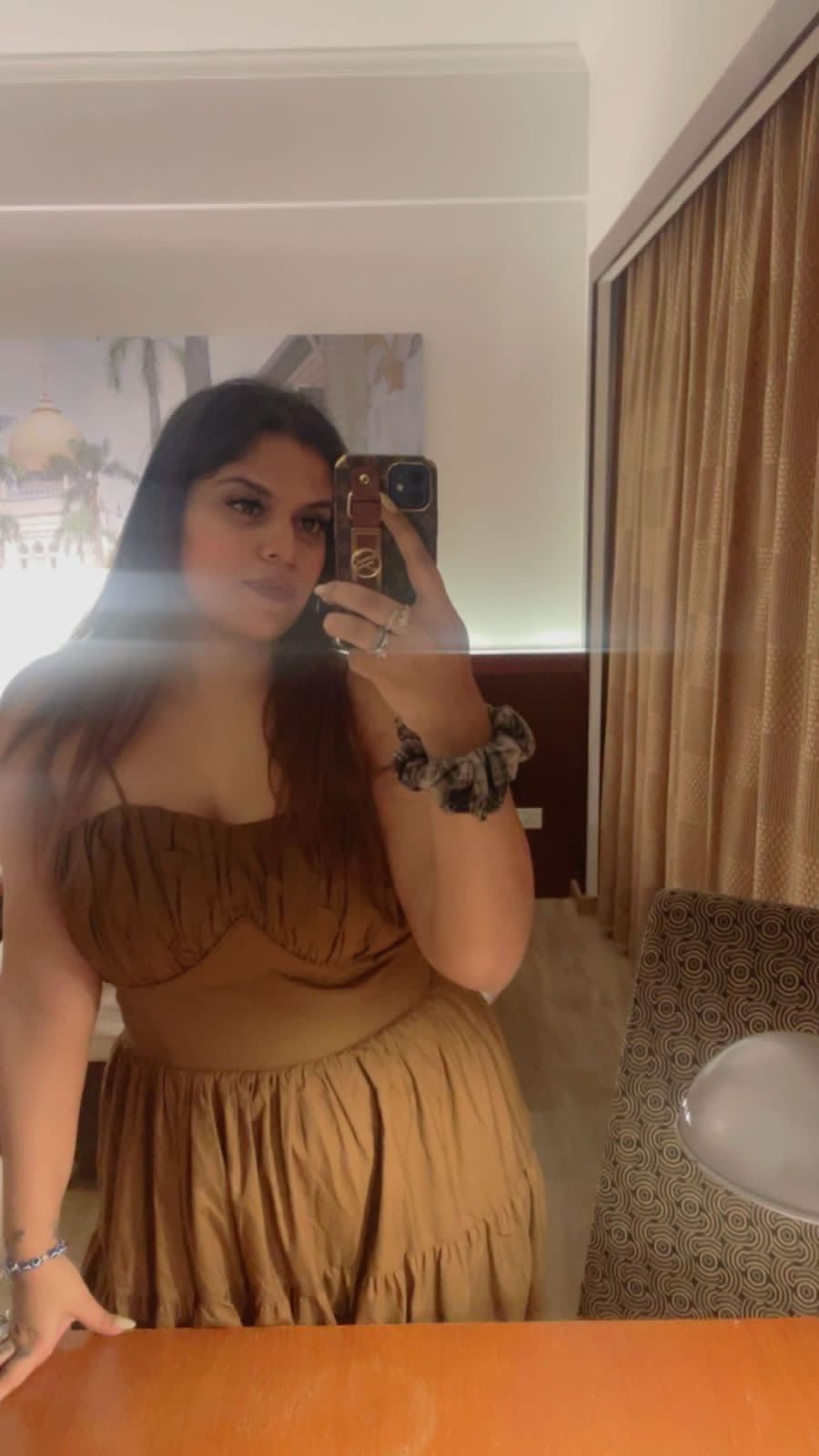 Mirror selfie portrait in light off-shoulder dress